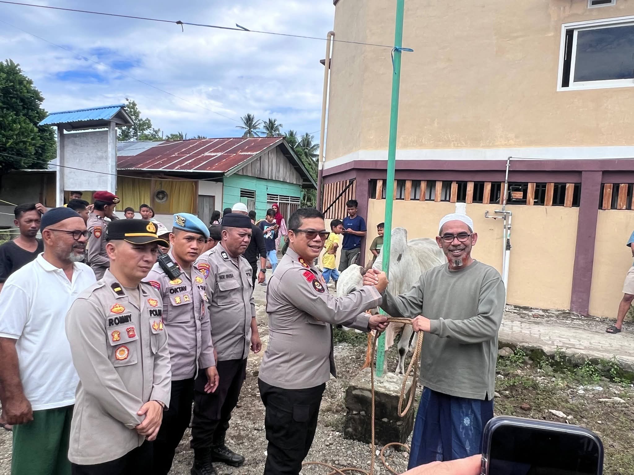 Kapolres Boltim, AKBP Golfried Hasiholan Pakpahan menyerahkan secara simbolis tali pengikat sapi kurban kepada Habib Umar Bin Assagaf di Kecamatan Nuangan, disaksikan jajaran PJU Polres Boltim dan tokoh masyarakat di Hari Raya Idul Adha 1447 H, Rabu (27/5/2026).