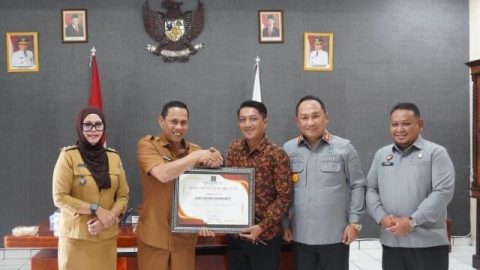 Caption: Abd David Mamonto (tengah, kemeja batik cokelat) menerima penghargaan sebagai paralegal teraktif dari Wali Kota (kiri Davit) yang diserahkan Kakanwilkum Sulut (kanan Davit) dan disaksikan Sangadi (paling kiri).